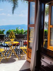 a balcony with a table with a vase of fruit on it at La belle èpoque in Milazzo