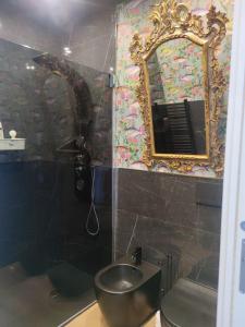 a bathroom with a sink and a mirror and a toilet at La belle èpoque in Milazzo
