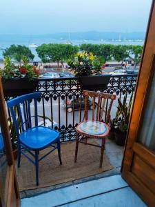 two chairs on a balcony with a view of a city at La belle èpoque in Milazzo +11 photos