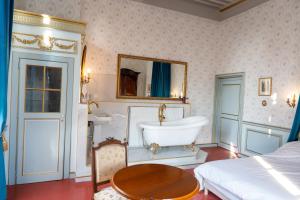 a bathroom with a tub and a bed and a table at Chateau de Mons Gard prés d Uzes in Mons +32 photos