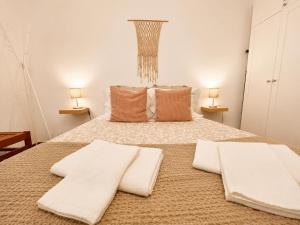 a bedroom with a bed with two white towels on it at Studio Gerês in Geres