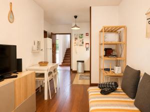 a living room with a couch and a table at Studio Gerês in Geres
