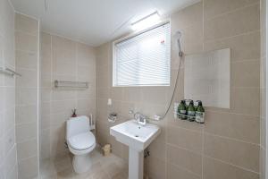 a bathroom with a white toilet and a sink at Visitor guesthouse in Jeju +44 photos