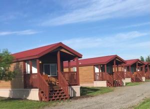 a row of cottages with red roofs at Eagle Peak Lodge & Cabins in Ashton