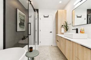 a bathroom with a tub and a sink and a toilet at Spa - River - Game Room - Le Belvedere in Mont-Tremblant +47 photos