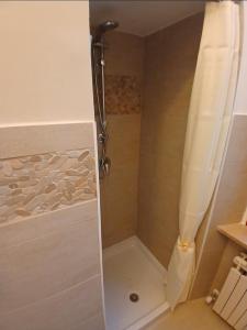 a shower with a shower curtain in a bathroom at Chimera 37 in Avezzano +5 photos