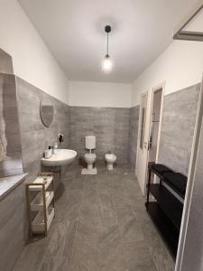 a bathroom with a sink and a toilet and a sink at Cascina Tesoriera in Santhià +5 photos