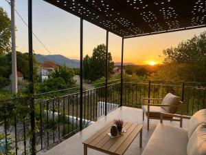 a balcony with a view of the sunset at Villa "Lala" in Ljubuški