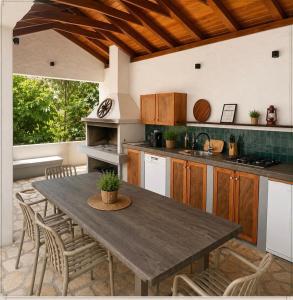 a kitchen with a wooden table and chairs at Villa "Lala" in Ljubuški