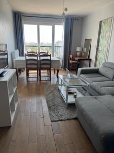 a living room with a couch and a table at Paris-Alfortville in Alfortville