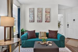 a living room with a blue couch and a table at Casa Oasis Temple 3BR 2BA Work Ready in Temple