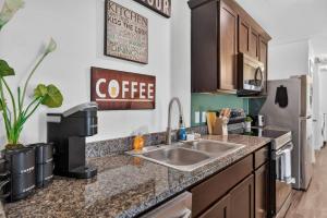 a kitchen with a sink and a coffee sign on the wall at Casa Oasis Temple 3BR 2BA Work Ready in Temple