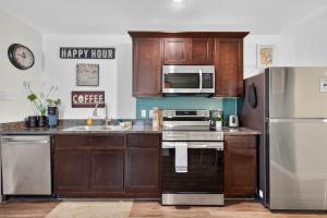 a kitchen with wooden cabinets and a refrigerator at Casa Oasis Temple 3BR 2BA Work Ready in Temple +24 photos