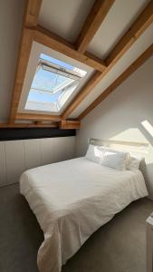 a bedroom with a large bed with a skylight at La Francesa de Eriste in Sahun