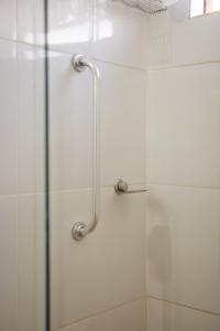 a shower in a bathroom with a glass door at Pousada Capão da Coruja in Santa Bárbara +38 photos