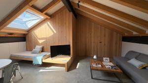 a room with a couch and a tv in a attic at La Francesa de Eriste in Sahun