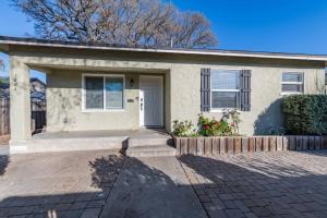 a small white house with a brick driveway at Park Street Apartment - Front Unit in Paso Robles