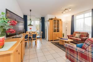 a living room with a dining table and a living room at Haus Roland, Wohnung 04 in Zinnowitz