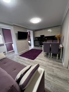 a living room with a couch and a dining room at Spacious apartment with a beautiful view in Căuşeni