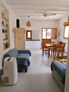 a living room with a couch and a table and a kitchen at Kortijo Martzala in Lucainena de las Torres