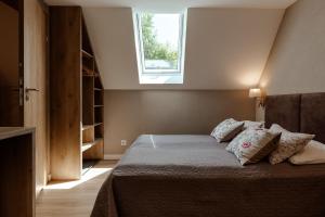 a bedroom with a bed with pillows and a window at Willa Karla in Krynica Zdrój +58 photos