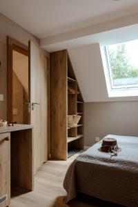 a bedroom with a bed and a large window at Willa Karla in Krynica Zdrój