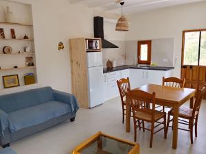 a living room with a table and a blue couch at Kortijo Martzala in Lucainena de las Torres +11 photos