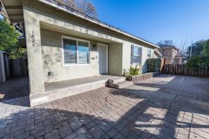 a house with a brick driveway in front of it at Park Street Apartment - Front Unit in Paso Robles
