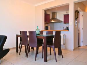 a kitchen with a dining room table and chairs at Le Channel - Parenthèse calme face à la mer sur la digue - Idéal famille - Équipements bébé - Ascenseur in Koksijde