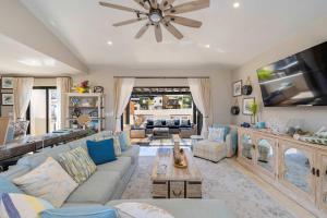 a living room with a couch and a tv at Luxury House with Ocean View in Cabo San Lucas