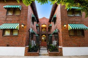 a brick building with a staircase in front at Downtown Houston Studio - Walk to Toyota Center in Houston