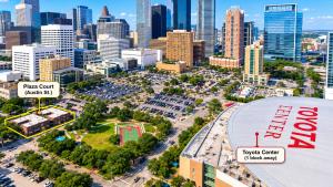 an aerial view of a parking lot in front of a city at Downtown Houston Studio - Walk to Toyota Center in Houston +3 photos