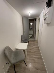 a living room with a table and a chair at Einzel Zimmer Metz in Metz