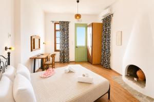 a living room with a couch and a fireplace at Uranos studios Amorgos in Amorgos +62 photos