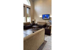 a living room with a couch and a table at GreenRidge Hotel in Wickliffe