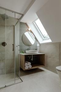 a bathroom with a sink and a glass shower at Willa Karla in Krynica Zdrój