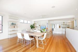 a kitchen and dining room with a table and chairs at Tranquil & Modern Riverside Getaway in Noosaville