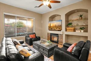 a living room with leather furniture and a fireplace at Movie Theater Pool Arcade Fire Pit in Glendale