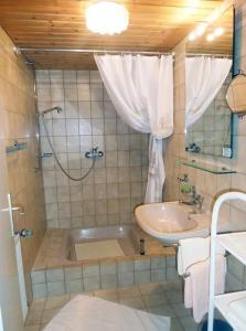 La salle de bains est pourvue d'une baignoire, d'un lavabo et d'une douche. dans l'établissement Wastlhof, à Schorndorf