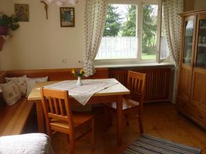 a dining room with a table and chairs and a window at Wastlhof in Schorndorf