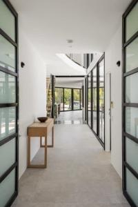 a hallway of a building with a table and windows at Luxury Retreat with Private Beach & Jetty in Noosa Heads +34 photos