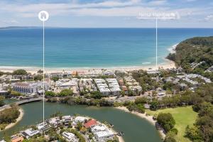 an aerial view of a resort next to the ocean at Luxury Retreat with Private Beach & Jetty in Noosa Heads