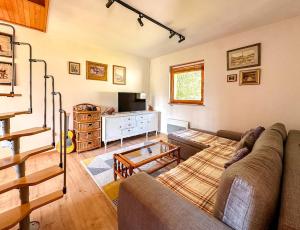 a living room with a couch and a television at Papa's Hideout Sarajevo in Buhotina