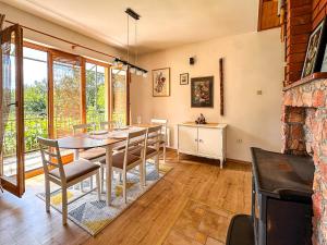 a dining room with a table and chairs at Papa's Hideout Sarajevo in Buhotina