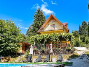 a house with chairs and a pool in front of it at Papa's Hideout Sarajevo in Buhotina