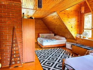 a attic room with two beds and a brick wall at Papa's Hideout Sarajevo in Buhotina +52 photos