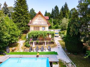 an aerial view of a house with a swimming pool at Papa's Hideout Sarajevo in Buhotina