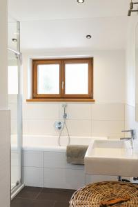 a bathroom with a bath tub and a sink at Alpen Chalet Forest in Mauterndorf +60 photos