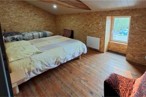 a bedroom with a large bed and a window at LE FIEF GUIBERT Chambres d'hôtes - gîtes - élevage de lamas en Vendée in Le Poiré-sur-Vie