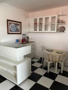 a kitchen and dining room with a table and chairs at Apartamento in Natal